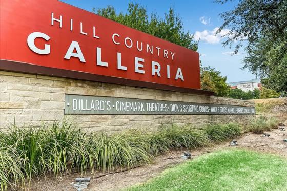 Hill Country Galleria entrance sign — Dillard's, Cinemark, Dick's, Whole Foods — next door
