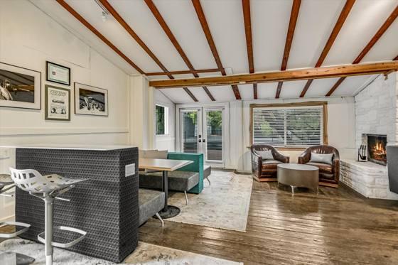 Suite 100 — fireplace lounge with French doors to the covered deck