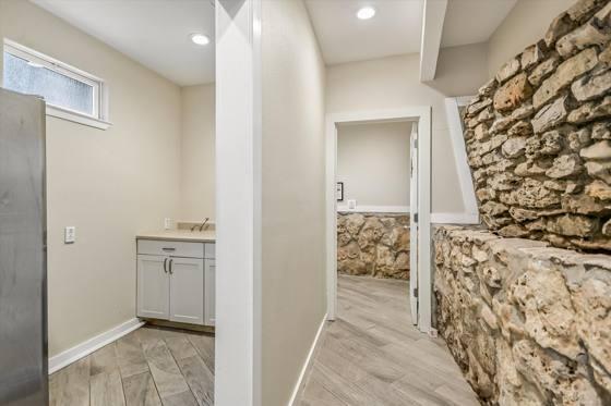 Suite G200 — kitchenette against the original stone