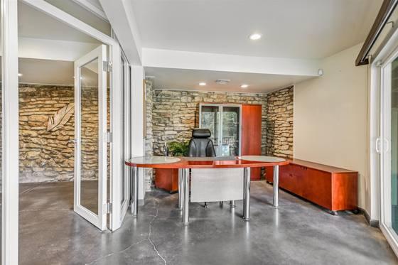 Suite G100 — executive office with limestone wall and garden access