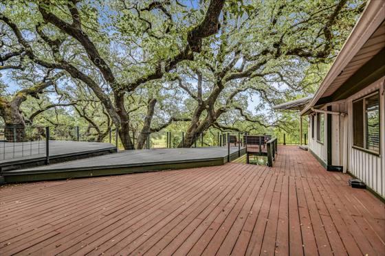 Upper deck under the live-oak canopy — beside Suite 100