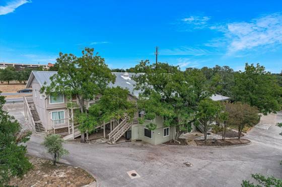 Aerial — the building nestled in the oaks